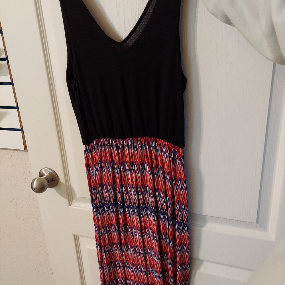 Sleeveless orange, blue, red patterned floor-length summer dress.